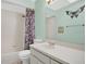 Well-lit bathroom area featuring bathtub, toilet, and sink with butterfly wall art at 6750 Lemon Tree Dr, Lakeland, FL 33813