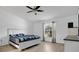 Bright bedroom features a ceiling fan, window with curtains, and light wood flooring at 6750 Lemon Tree Dr, Lakeland, FL 33813