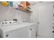 Laundry room featuring a Whirlpool washer and dryer unit, and a wire shelf at 6750 Lemon Tree Dr, Lakeland, FL 33813