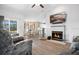 Open-concept living room with a fireplace, wood floors, and lots of natural light at 6750 Lemon Tree Dr, Lakeland, FL 33813