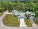 Aerial view of the property showcasing the home, the yard, the driveway and surrounding trees at 6810 Palomino Dr, Lakeland, FL 33811