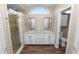Bathroom featuring a double vanity, granite countertops, and a glass-enclosed shower at 6810 Palomino Dr, Lakeland, FL 33811