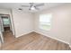 Bedroom featuring wood-look floors, a ceiling fan, a window, and neutral-colored walls at 6810 Palomino Dr, Lakeland, FL 33811
