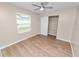 Bedroom with wood floors, a ceiling fan, a window, and closet with sliding doors at 6810 Palomino Dr, Lakeland, FL 33811