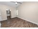 Bedroom with wood-look floors, a ceiling fan, and a view into an en-suite bathroom at 6810 Palomino Dr, Lakeland, FL 33811