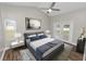 A staged bedroom boasts wood floors, neutral walls, ceiling fan and a sliding glass door leading outside at 6810 Palomino Dr, Lakeland, FL 33811