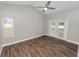 Bedroom featuring wood floors, neutral walls, a ceiling fan, a window, and a sliding glass door leading outside at 6810 Palomino Dr, Lakeland, FL 33811