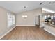 An ample dining area illuminated by natural light, complemented by a modern chandelier at 6810 Palomino Dr, Lakeland, FL 33811