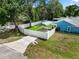 Exterior view of a blue home with a fenced yard and concrete driveway leading to a carport at 6810 Palomino Dr, Lakeland, FL 33811