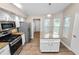 Bright kitchen featuring stainless steel appliances, granite countertops, and an island at 6810 Palomino Dr, Lakeland, FL 33811