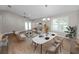 Open-concept living room with stylish furniture, chandelier, fan, and ample natural light at 6810 Palomino Dr, Lakeland, FL 33811