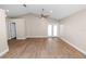 Expansive living area with wood-style flooring, featuring french doors and neutral paint at 6810 Palomino Dr, Lakeland, FL 33811