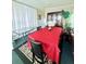 Cozy dining area with a large table, bright red tablecloth, and natural light at 816 Elizabeth Ln, Lakeland, FL 33809