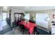 Dining area featuring a red-covered table, display cabinet and multiple windows at 816 Elizabeth Ln, Lakeland, FL 33809