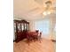 Cozy dining area with hardwood floors, a ceiling fan, and a classic china cabinet at 816 Elizabeth Ln, Lakeland, FL 33809