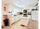 Bright kitchen with white cabinets, an island cooktop, and modern appliances at 816 Elizabeth Ln, Lakeland, FL 33809