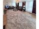 Open-concept living room with a plush rug, leather sofa, and decorative coffee table at 816 Elizabeth Ln, Lakeland, FL 33809