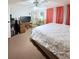 Comfortable bedroom with a plush bed, dresser, and TV, bathed in soft, natural light at 816 Elizabeth Ln, Lakeland, FL 33809
