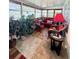 Cozy sunroom with red wicker furniture, tile flooring, and abundant natural light at 816 Elizabeth Ln, Lakeland, FL 33809