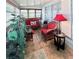 Bright sunroom featuring wicker furniture, tile flooring, and plenty of windows at 816 Elizabeth Ln, Lakeland, FL 33809