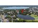 Aerial view showcasing the property's location near a scenic lake, surrounded by lush greenery and neighborhood homes at 921 Avon Ave, Lakeland, FL 33801