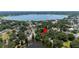 Scenic aerial view of the property nestled among lush trees, near a tranquil lake and residential neighborhood at 921 Avon Ave, Lakeland, FL 33801