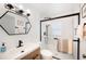 Modern bathroom features a glass enclosed shower and designer mirror at 921 Avon Ave, Lakeland, FL 33801