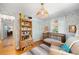 Charming Bedroom features hardwood floors, fun wallpaper, and a cozy crib at 921 Avon Ave, Lakeland, FL 33801