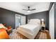 Bedroom featuring a ceiling fan, wood floors, and neutral decor at 921 Avon Ave, Lakeland, FL 33801