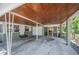 View of the covered carport showing a garage door, access to the house, and a screened-in porch at 921 Avon Ave, Lakeland, FL 33801