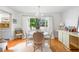 Bright dining area features hardwood floors, a round table with seating for four, and a window with natural light at 921 Avon Ave, Lakeland, FL 33801