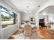 Bright dining area features hardwood floors, a round table with seating for four, and a large window with natural light at 921 Avon Ave, Lakeland, FL 33801