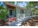 Exterior showcasing the home's welcoming front entrance, decorative plantings, and a charming covered carport at 921 Avon Ave, Lakeland, FL 33801
