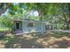 Charming home with a covered front entry, complemented by beautiful landscaping with vibrant greenery at 921 Avon Ave, Lakeland, FL 33801