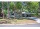 Inviting home featuring a covered carport, manicured lawn, and mature trees, offering great curb appeal at 921 Avon Ave, Lakeland, FL 33801