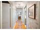Hallway with flamingo wallpaper, wood floors and multiple doorways at 921 Avon Ave, Lakeland, FL 33801