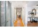Hallway with flamingo wallpaper, wood floors and stylish light fixture at 921 Avon Ave, Lakeland, FL 33801