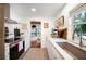 Galley kitchen featuring stainless appliances, tile floors and marble countertops at 921 Avon Ave, Lakeland, FL 33801