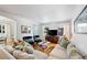 Spacious living room with hardwood floors, a cozy seating arrangement, and natural light streaming through the windows at 921 Avon Ave, Lakeland, FL 33801