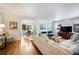 Bright living room featuring hardwood floors, a white sofa, and an open archway leading to the dining area at 921 Avon Ave, Lakeland, FL 33801