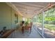 Inviting screened-in porch with string lights and wooden table, perfect for outdoor dining and relaxation at 921 Avon Ave, Lakeland, FL 33801