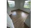 This bedroom features light wood floors and windows that provide ample natural light at 930 E Tee Cir, Bartow, FL 33830