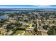 Stunning aerial view of a house with mature trees in a charming neighborhood near a peaceful lake at 1 Brogden Se Ct, Winter Haven, FL 33880