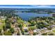 Aerial neighborhood view of a home near a serene lake, surrounded by lush greenery and mature trees at 1 Brogden Se Ct, Winter Haven, FL 33880