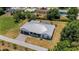 This aerial shows the home's well manicured lawn, modern roof, large driveway and screened pool at 1 Brogden Se Ct, Winter Haven, FL 33880