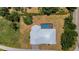 An aerial view shows a home with a modern roof, screened pool, driveway and well manicured lawn at 1 Brogden Se Ct, Winter Haven, FL 33880