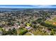 Expansive aerial view of a beautiful home nestled in a lush, green neighborhood near a serene lake at 1 Brogden Se Ct, Winter Haven, FL 33880