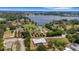 A neighborhood aerial view of a home near a serene lake, and surrounded by lush greenery and mature trees at 1 Brogden Se Ct, Winter Haven, FL 33880