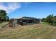 Spacious backyard featuring a screened-in pool and a charming playset, ideal for Gathering fun at 1 Brogden Se Ct, Winter Haven, FL 33880