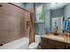Bathroom featuring tiled bathtub and granite countertop vanity at 1 Brogden Se Ct, Winter Haven, FL 33880